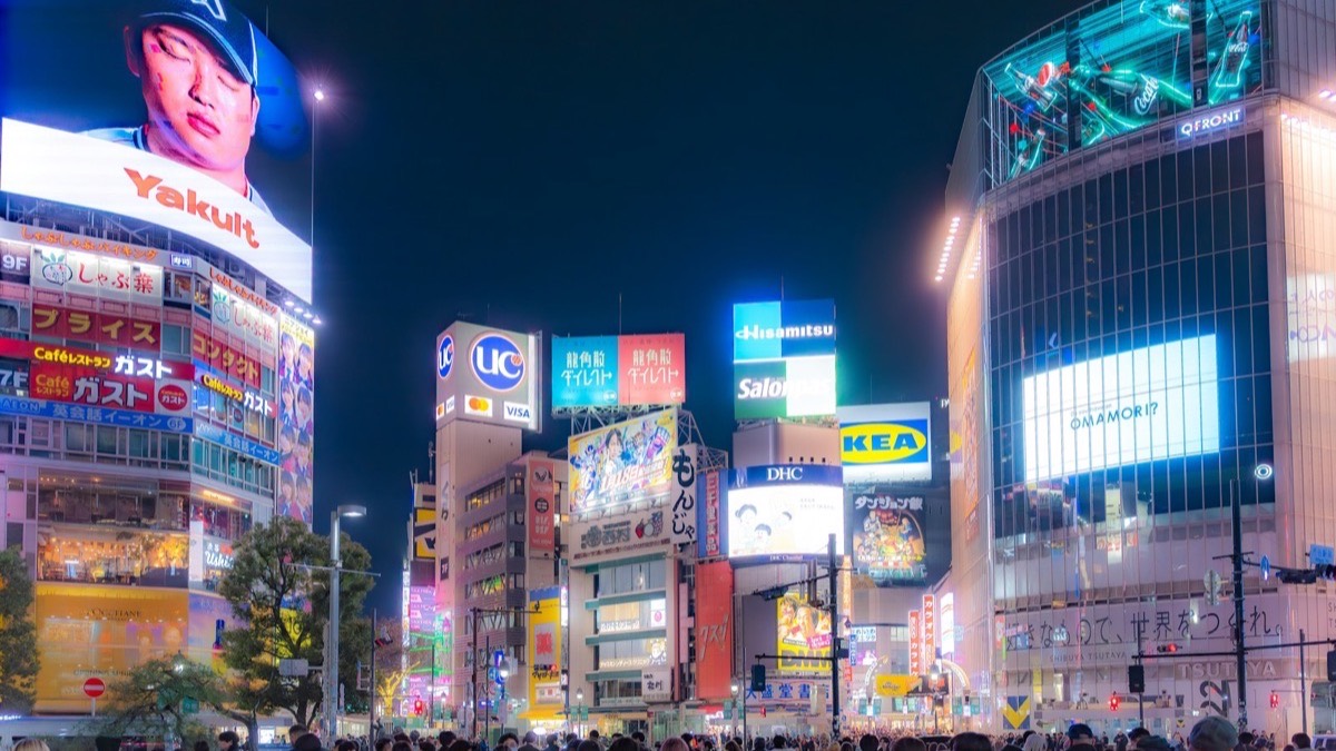 Neon shopping signs above Shibuya at night